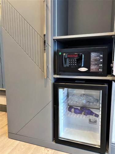 a refrigerator with its door open with food inside at Atar Airport Hotel - Spa & Wellness in Arnavutköy