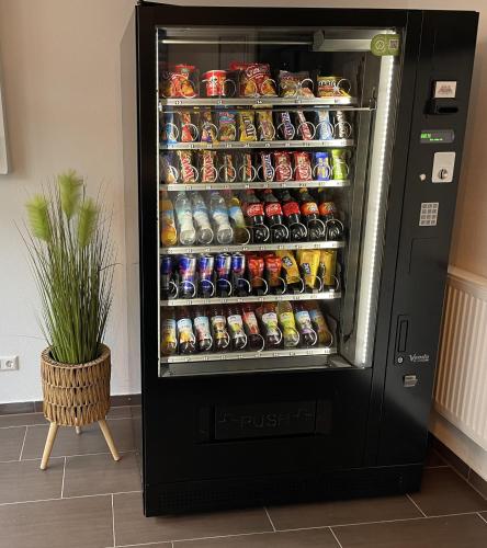 a refrigerator filled with lots of sodas and drinks at A&C Hotel in Backnang