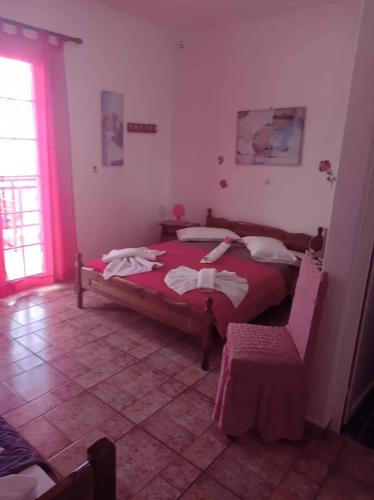 a bedroom with a bed and a chair in it at The Captain in Elafonisos
