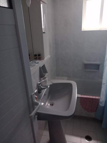 a bathroom with a sink and a mirror at The Captain in Elafonisos