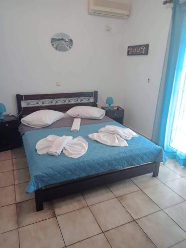 a bedroom with a bed with two towels on it at The Captain in Elafonisos