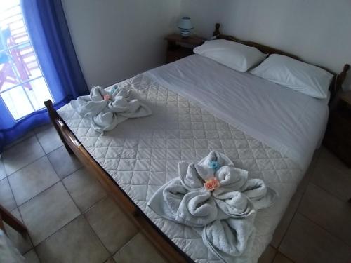 a bedroom with a bed with towels on it at The Captain in Elafonisos