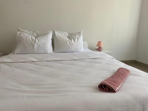 a white bed with white pillows and a towel on it at Gatto in Jajce