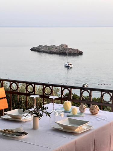 a white table with a view of the ocean at Villa Milan in Sveti Stefan