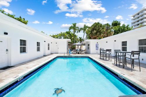 a swimming pool with a turtle on the side of a house at The Hotel Deauville in Fort Lauderdale