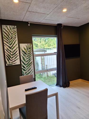 an office with a table and chairs and a window at EngholmBB in Odense