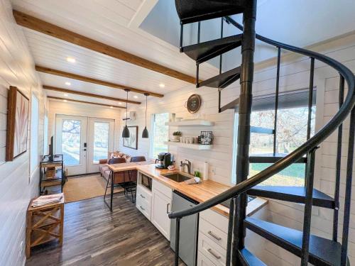 a kitchen and staircase in a tiny house at NEW The Flagship 2 Story Container Home in Waco