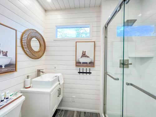 a bathroom with a sink and a shower at NEW The Flagship 2 Story Container Home in Waco