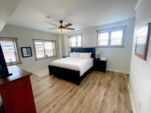 a bedroom with a bed and a ceiling fan at The Penthouse in Downtown in Fayetteville
