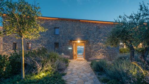 a brick building with a door and a pathway at Real Life Homes luxurious seafront villas each with their own private pools in Korakokhórion