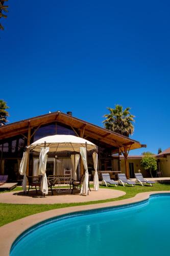 a resort with a tent and chairs and a pool at Parcela Olmué La Luz in Olmué