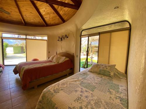 a bedroom with two beds and a large mirror at Parcela Olmué La Luz in Olmué