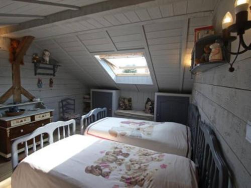 a bedroom with two beds in a attic at LE POINT DU JOUR 88460 DOCELLES in Docelles
