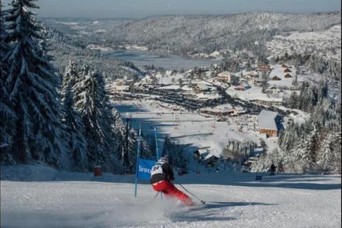 a person is skiing down a snow covered slope at LE POINT DU JOUR 88460 DOCELLES in Docelles