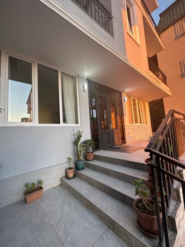 a front porch of a home with potted plants at WoodSea in Batumi