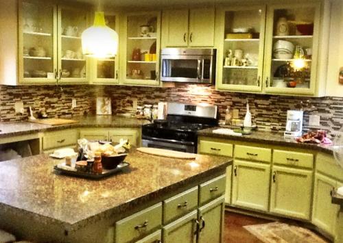 a kitchen with white cabinets and a counter top at Hallelujah Forest in Big Bear Lake