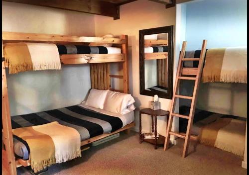 a room with two bunk beds and a mirror at Hallelujah Forest in Big Bear Lake