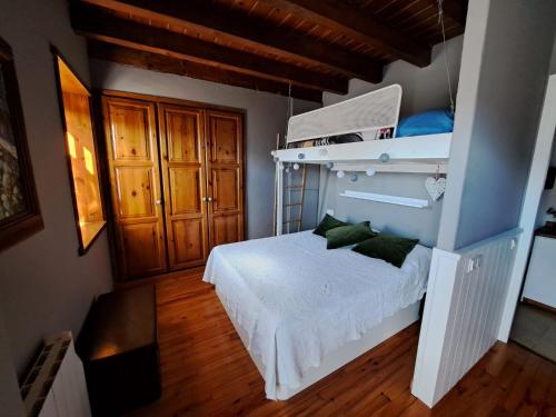 a bedroom with a white bed with green pillows at Apartamento con encanto in Pla de l'Ermita