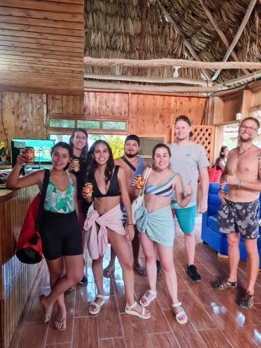 a group of people posing for a picture in a bar at El Retiro Lanquin in Lanquín