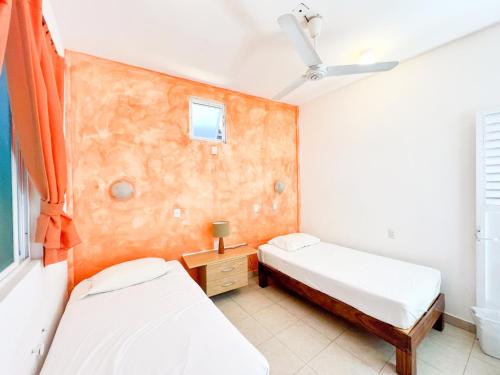 a bedroom with two beds and a window at ITH Sayulita Amazing Surf Hostel in Sayulita
