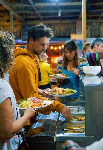 a man holding a plate of food at a buffet at El Retiro Lanquin in Lanquín