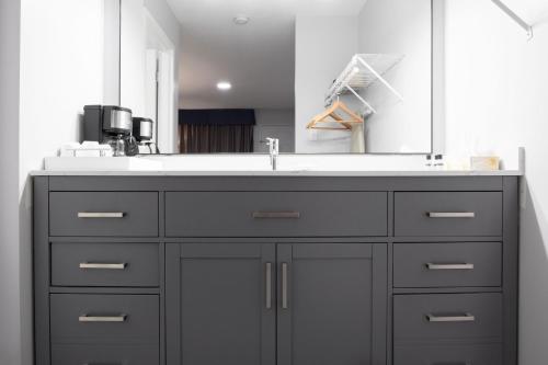 a bathroom vanity with a sink and a mirror at Copper Mountain Inn and Suites in Princeton