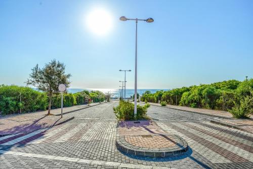 an empty street with a street light and trees at Sunny apartments in La Mata, Azul Beach 2 in Torrevieja
