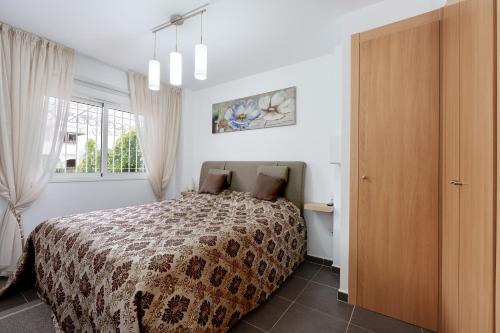 a bedroom with a bed and a window at Sunny apartments in La Mata, Azul Beach 2 in Torrevieja