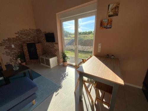 a kitchen with a large window and a living room at Well-being in Eifel in Nettersheim