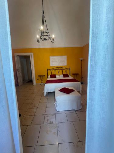a bedroom with two beds and a chandelier at B&B Al Castello in Sammichele di Bari
