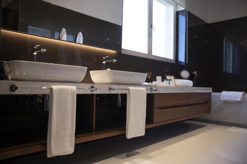 a bathroom with two sinks and a large mirror at Celine in Savudrija
