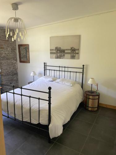 a bedroom with a bed and two horses on the wall at Chateau pool house in Assat