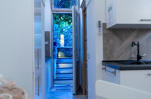 a kitchen with a staircase leading to a door at INSULA LUBRENSIS flat in Massa Lubrense