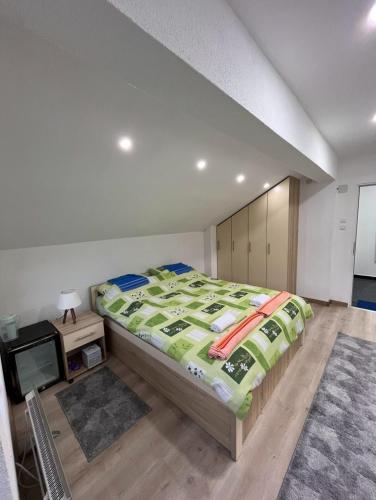 a bedroom with a large bed and a tv at Vikendica Teodora - Zvornik in Zvornik