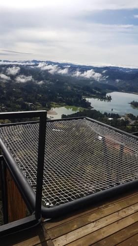 a viewing deck with a view of a lake at Glamping La Montaña Sagrada in Medellín
