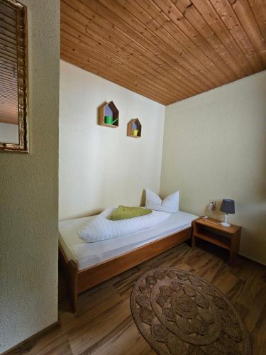 a bedroom with a bed with a wooden ceiling at Pension Schatzkisterl in Zwiesel