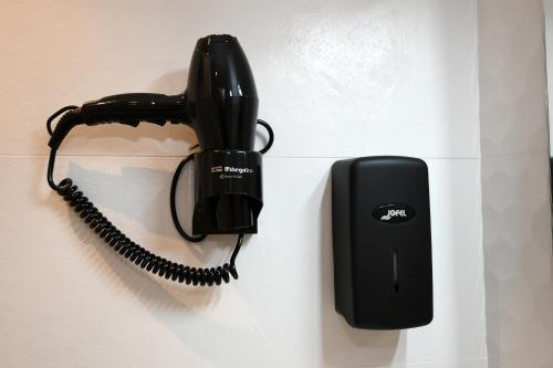 a black phone next to a corded phone at Duerming Sanxenxo Silgar VUT in Sanxenxo