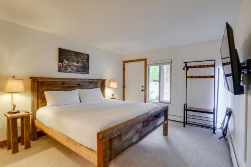 a bedroom with a bed and a flat screen tv at Walk to Ski Shuttle: Cozy Mountain Meadows Condo in Frisco