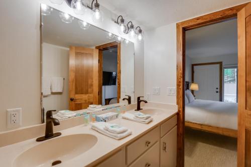 a bathroom with a sink and a large mirror at Walk to Ski Shuttle: Cozy Mountain Meadows Condo in Frisco