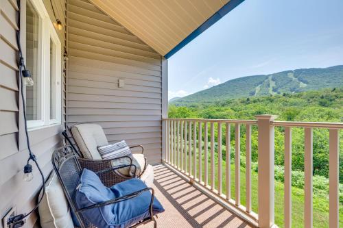 a balcony with a chair and a view of the mountains at Lincoln Condo with Resort Amenities and Mountain Views in Lincoln
