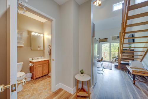 a bathroom with a toilet and a sink and a staircase at Lincoln Condo with Resort Amenities and Mountain Views in Lincoln