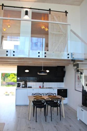 a kitchen with a table and chairs in a kitchen at Sea2 in Nowęcin