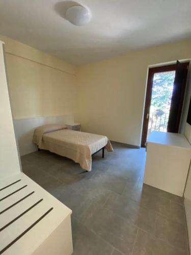 a bedroom with a bed and a large window at Casa Al Lago B&B in Foiano di Val Fortore