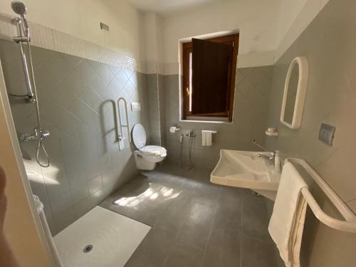 a bathroom with a toilet and a sink at Casa Al Lago B&B in Foiano di Val Fortore