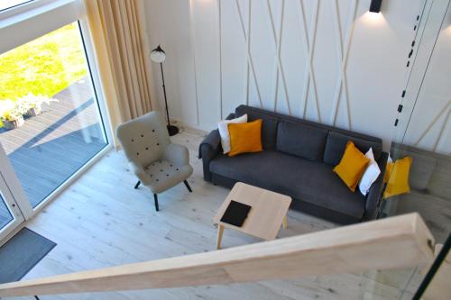 a living room with a couch and a chair at Sea2 in Nowęcin