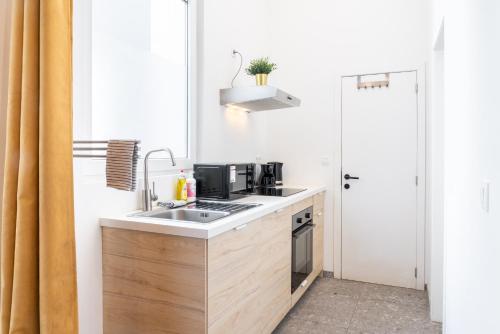 a small kitchen with a sink and a stove at Saint Pauls Apartments in Antwerp
