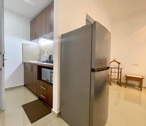 a kitchen with a large stainless steel refrigerator at RESIDENCE D ANKADIFOTSY in Antananarivo