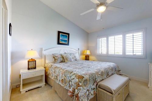a bedroom with a bed and a ceiling fan at 207 Sailmaker in Fernandina Beach