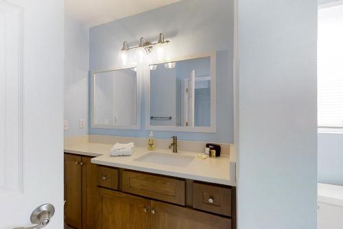 a bathroom with a sink and a mirror at 212 Sailmaker in Fernandina Beach