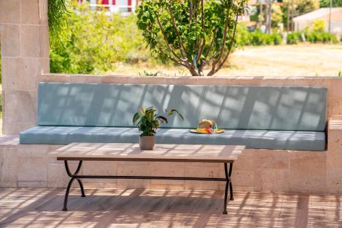 a bench with a table and a plate of food on it at Claire villa in Sami